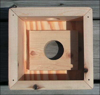 A hole is cut through the top base board and its reinforceing piece.