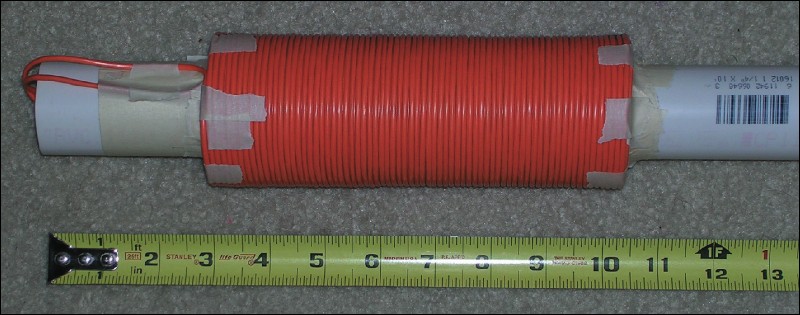 All six layers have been wrapped. Note that there are now two lenghts  of extra wire that have been tucked into the PVC pipe.